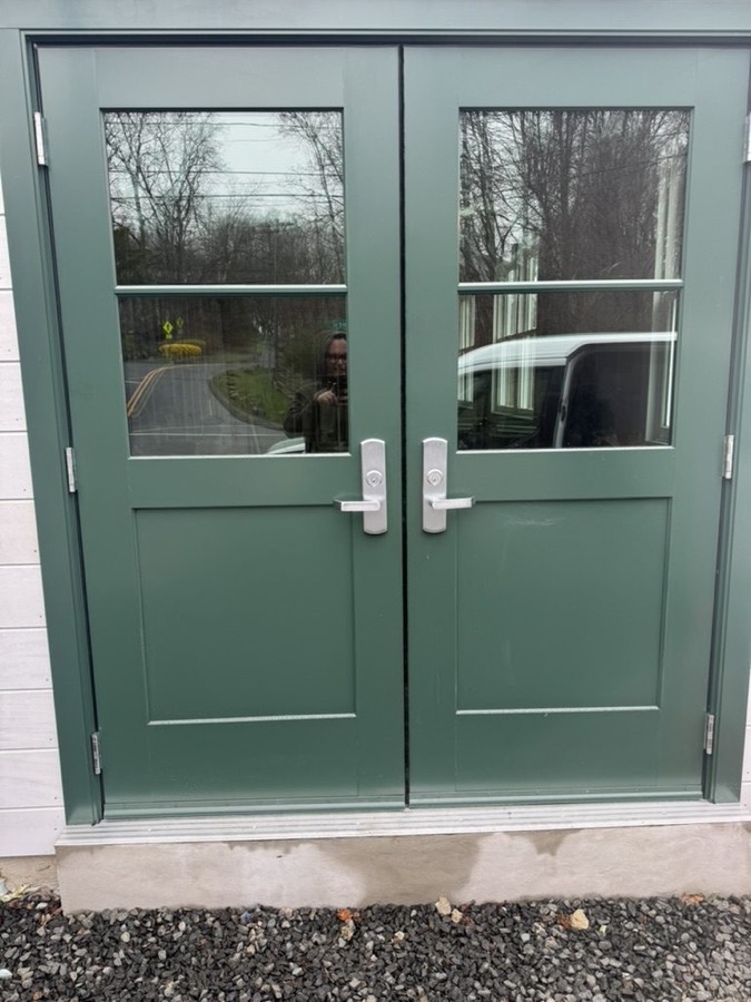 Green painted double entry doors with glass panels