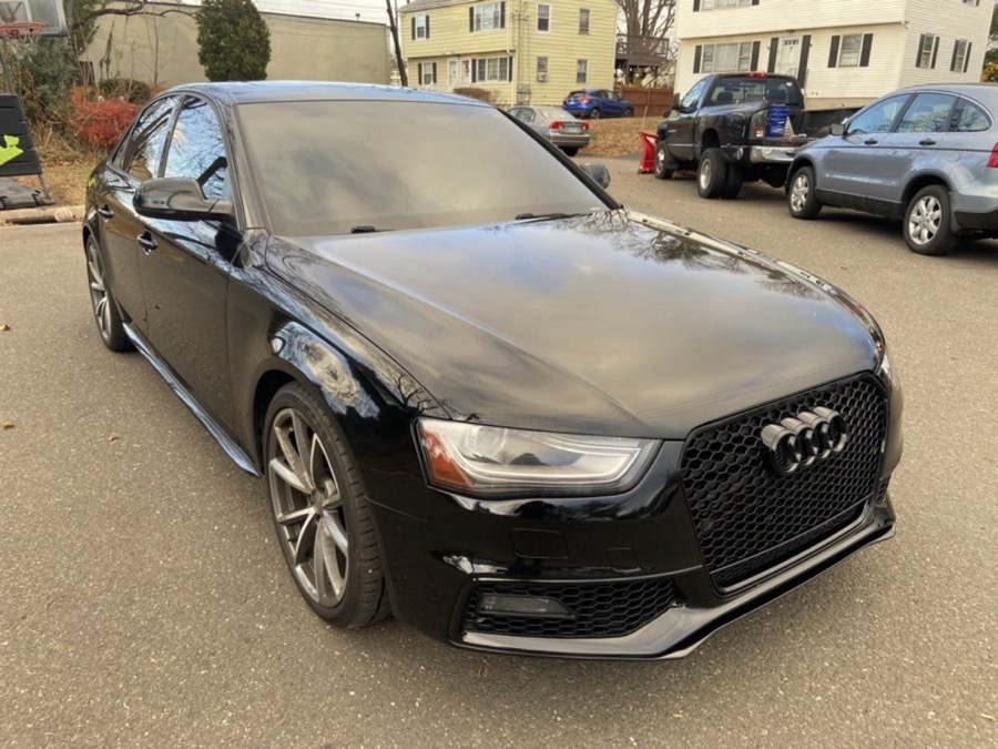 Detailed black Audi sedan parked on a residential street